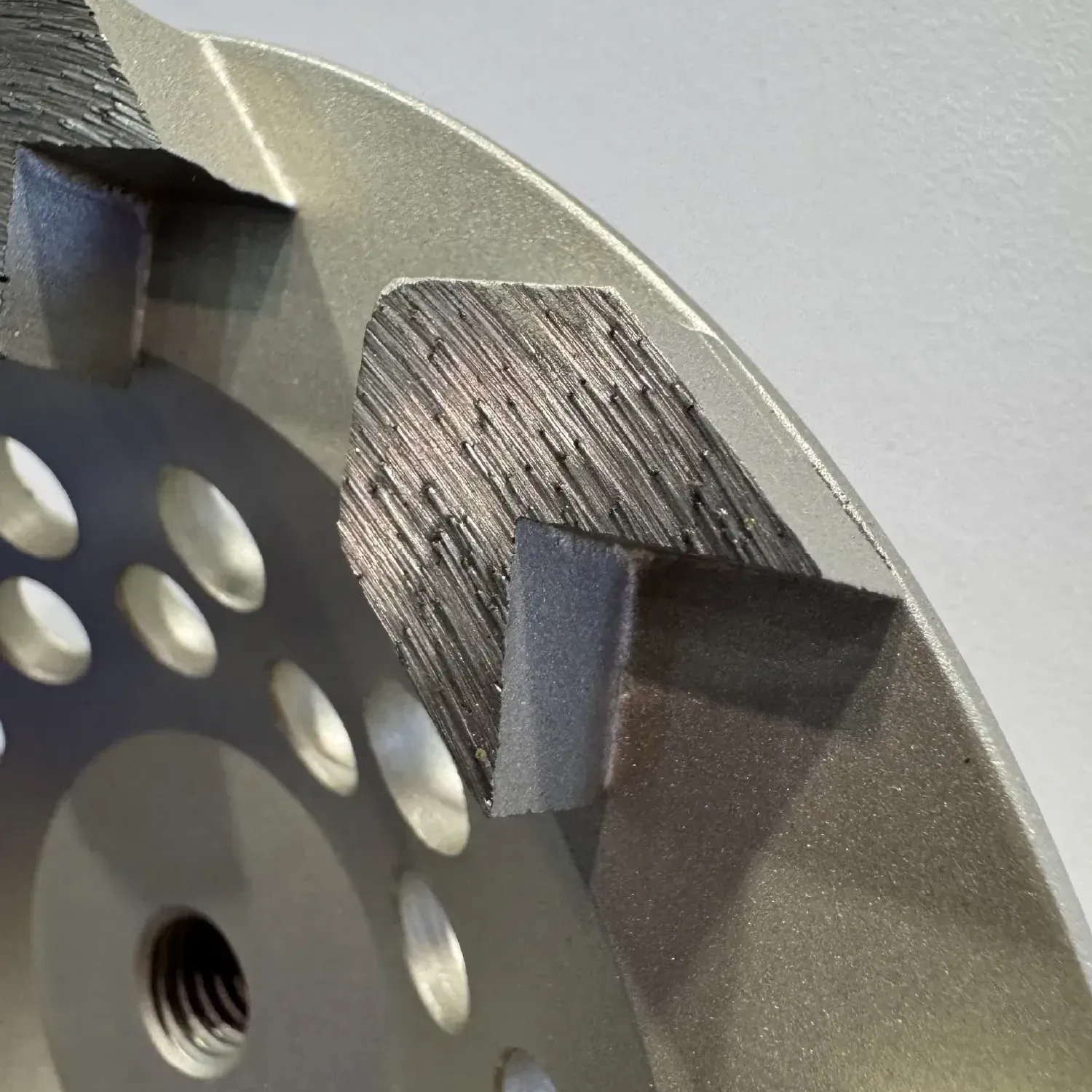 Diamond Vantage Arrow Segment Diamond Grinding Cup Wheel 4 Side profile shot of high-profile arrow diamond segment on concrete texture.