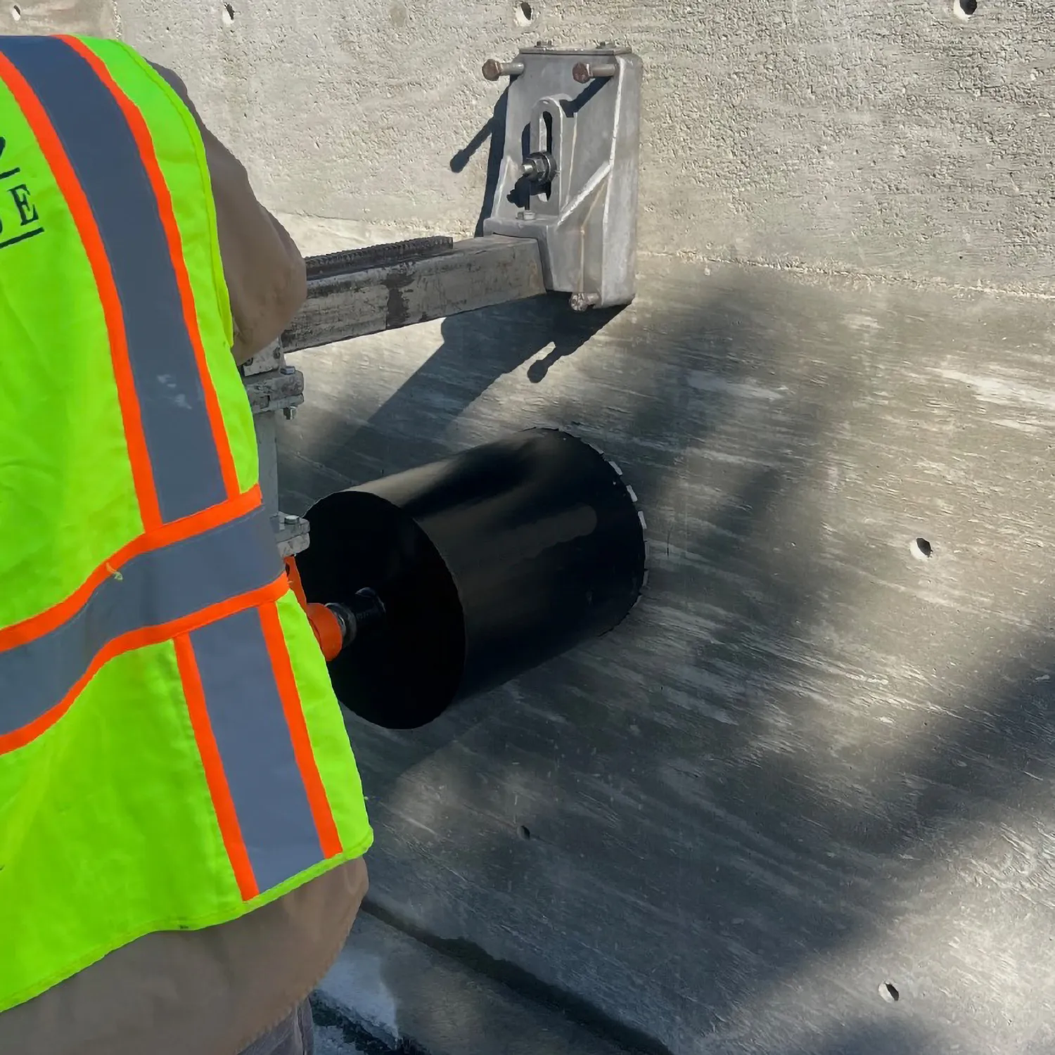 Diamond Vantage X300 Concrete Wet Diamond Core Drill Bit 6 A contractor using a core drill rig with an X300 premium wet diamond core drill bit to drill through a reinforced concrete wall.
